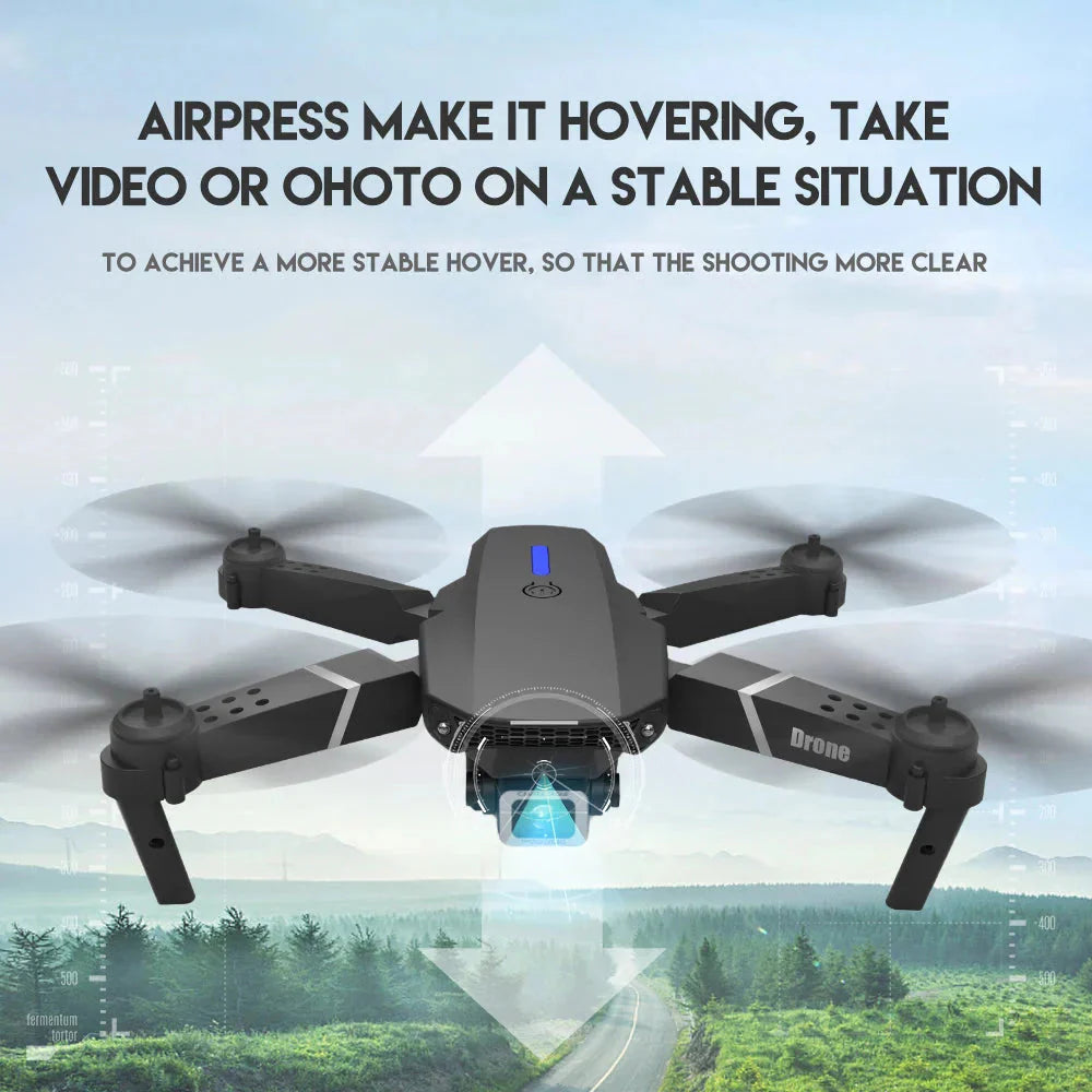4K foldable drone with camera hovering in the air over a forested road background
