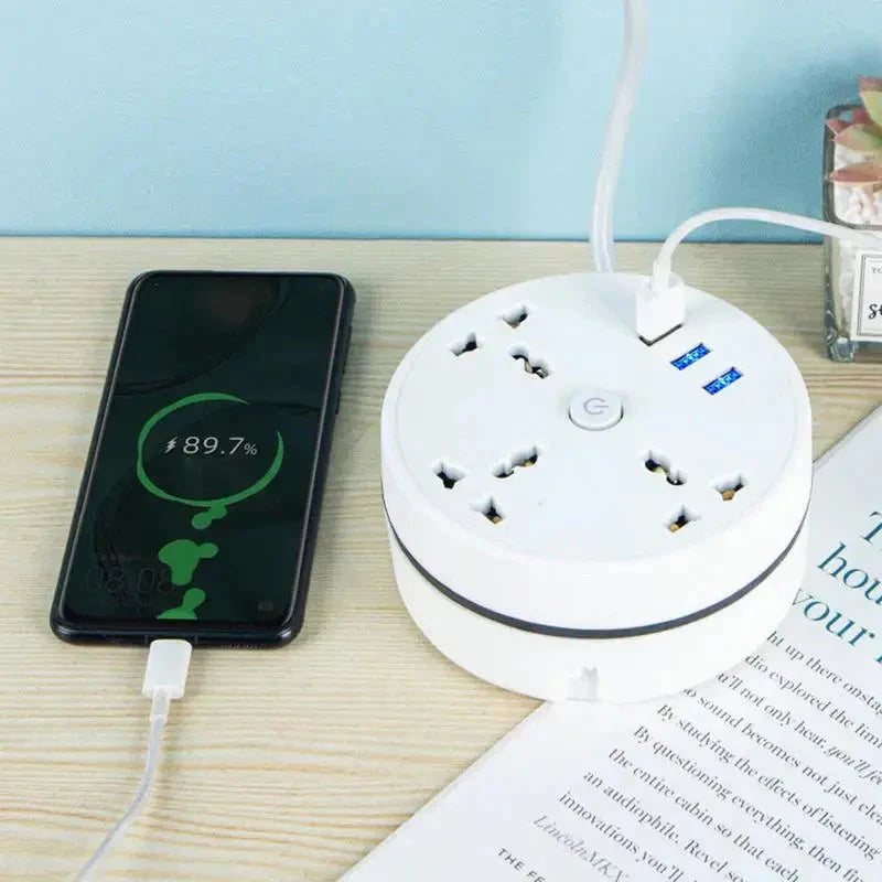 EU plug smart power strip with multiple outlets and USB ports charging a smartphone on a wooden desk